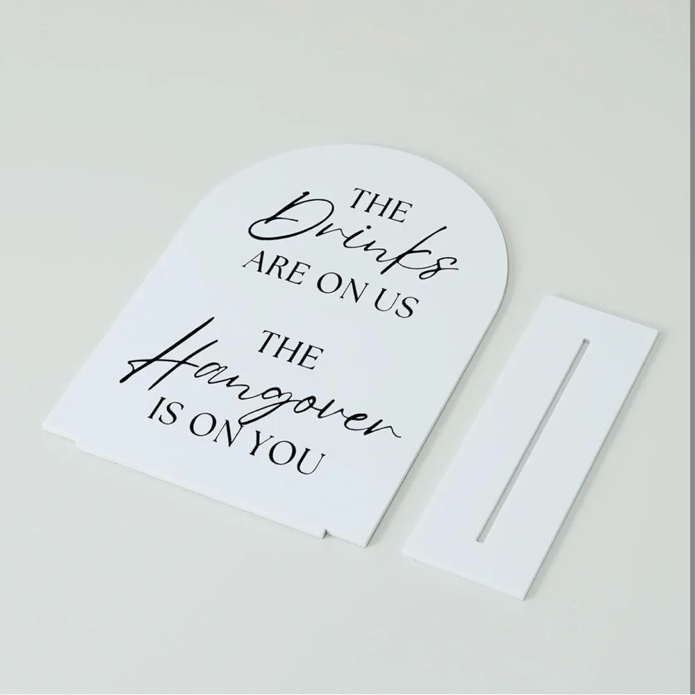Black and white Wedding sign. The drinks are on us the hangover is on you
